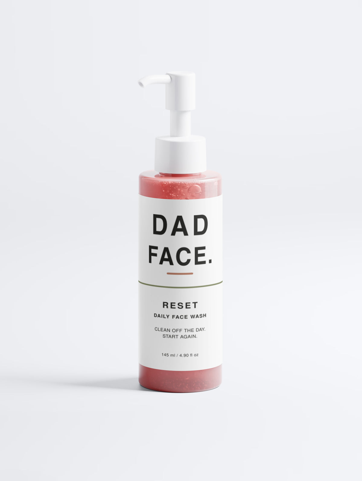 A bottle of Dad Face Reset Daily Face Wash with a white pump dispenser and a white label, showing pinkish-red liquid inside, on a clean white background.